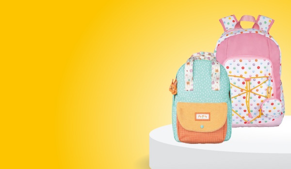 Várias mochilas sobre um pódio e um fundo amarelo